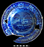 Pearlware soup plate printed underglaze in dark blue. Continuous repeating floral rim motif. This vessel is unmarked, but marked vessels with this pattern have shown pattern to be “American Villa” by Bourne, Baker & Bourne (1813-1833), Fenton, Staffordshire. 10” ” rim diameter.